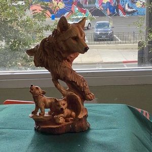 Mama wolf frolicking with her cubs